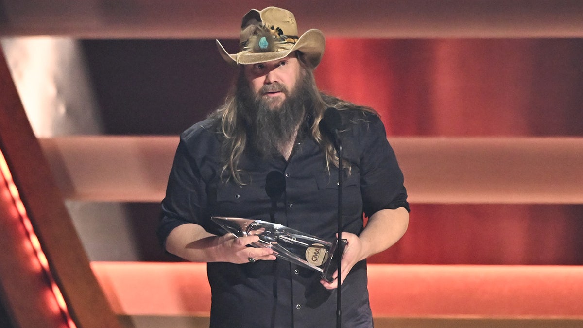 Chris Stapleton holding CMA Award