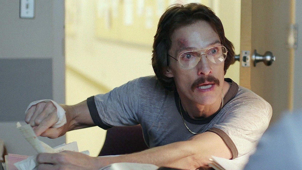 Matthew McConaughey in a grey shirt with brown ribbing looks desperate in a still from "Dallas Buyers Club"