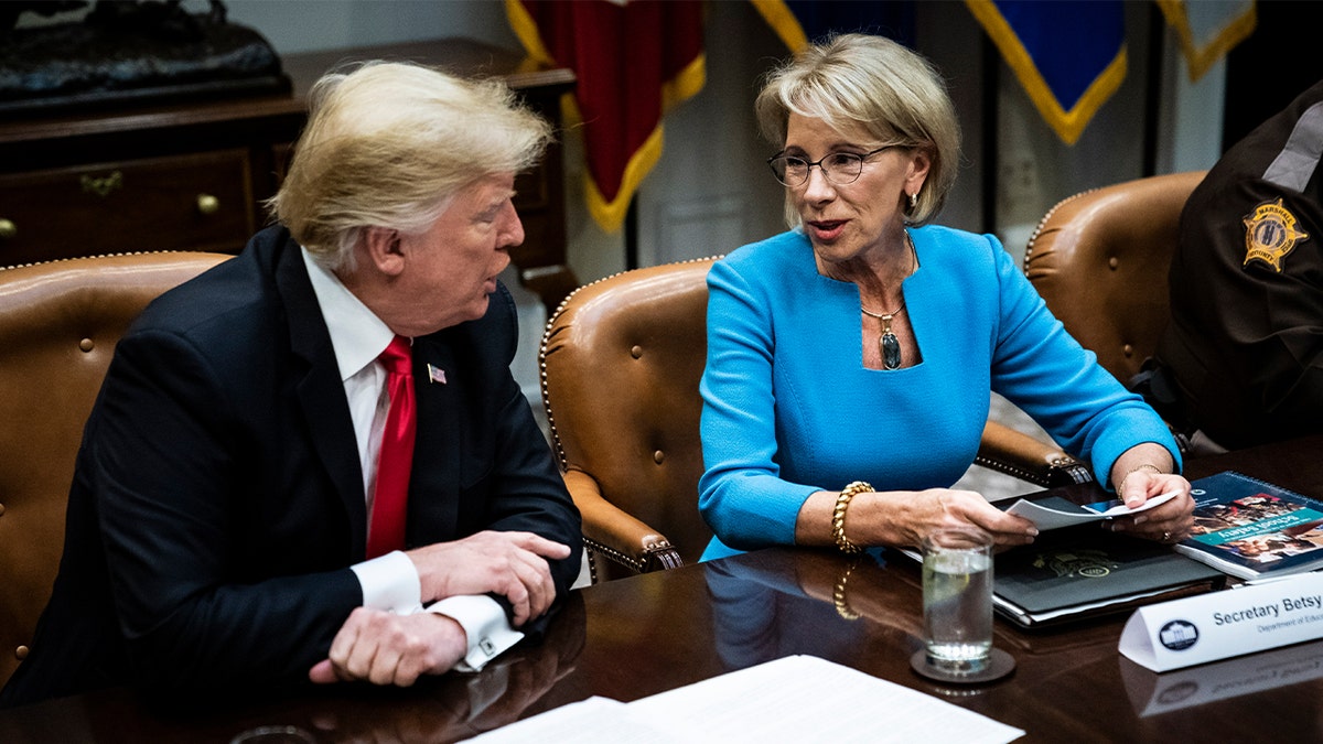 FILE - President Donald Trump speaks with then-Secretary of Education Betsy DeVos in the Roosevelt Room at White House on Dec. 18, 2018 in Washington, D.C.