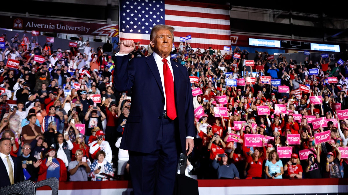 Republican presidential nominee, former President Donald Trump holds up a fist at a campaign rally at the Santander Arena on November 04, 2024 in Reading, Pennsylvania. With one day left before the general election, Trump is campaigning for re-election in the battleground states of North Carolina, Pennsylvania and Michigan.