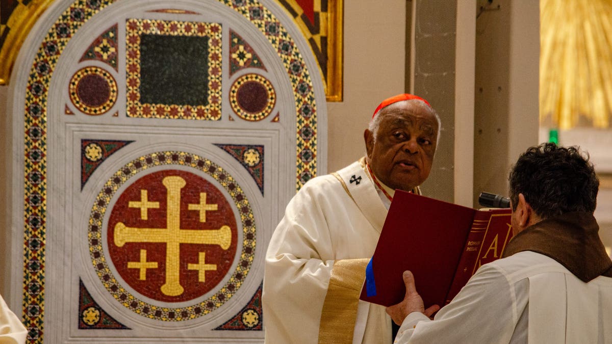 Cardinal Wilton Gregory of the Archdiocese of Washington celebrates a Catholic Mass at the Franciscan Monastery of the Holy Land in America in Washington, D.C. A mosaic of the "Cross of Jerusalem" decorates the cardinal's seat. 