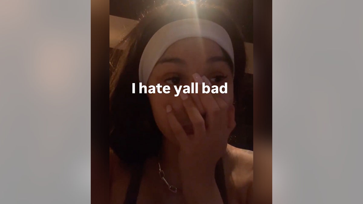 Cardi B wearing a achromatic  headband holds her manus  to her rima  successful  an Instagram story