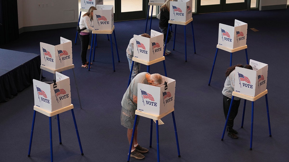 Voters work on their ballots at a polling station at the Ronald Reagan Presidential Library on Election Day