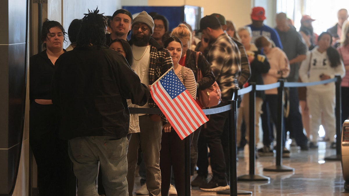 People stand in line to vote on Election Day 2024