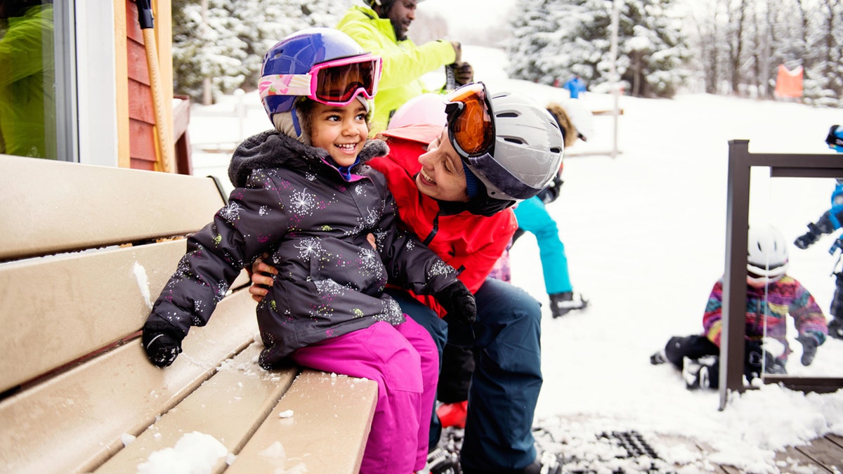 A parent  and girl  connected  a skip travel   together