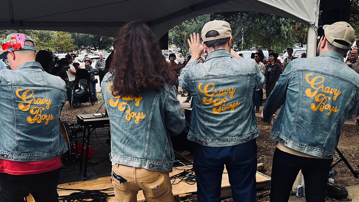 Four men wearing jean jackets reading "Gravy Boys."