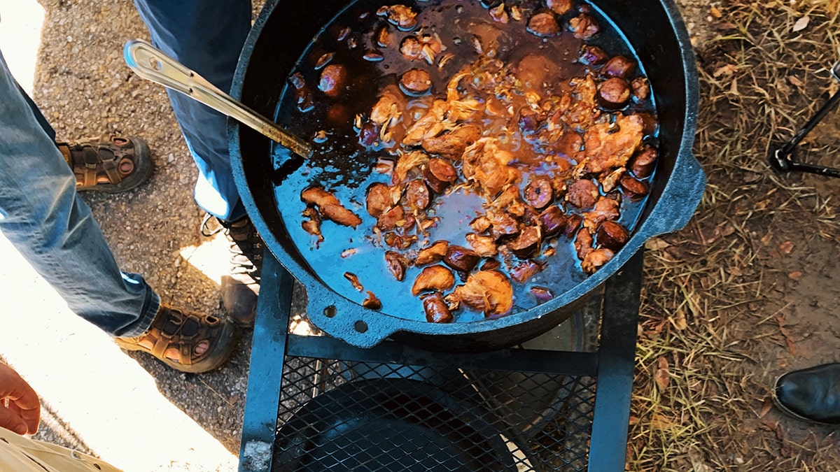 A dutch oven full of what looks like a stew.