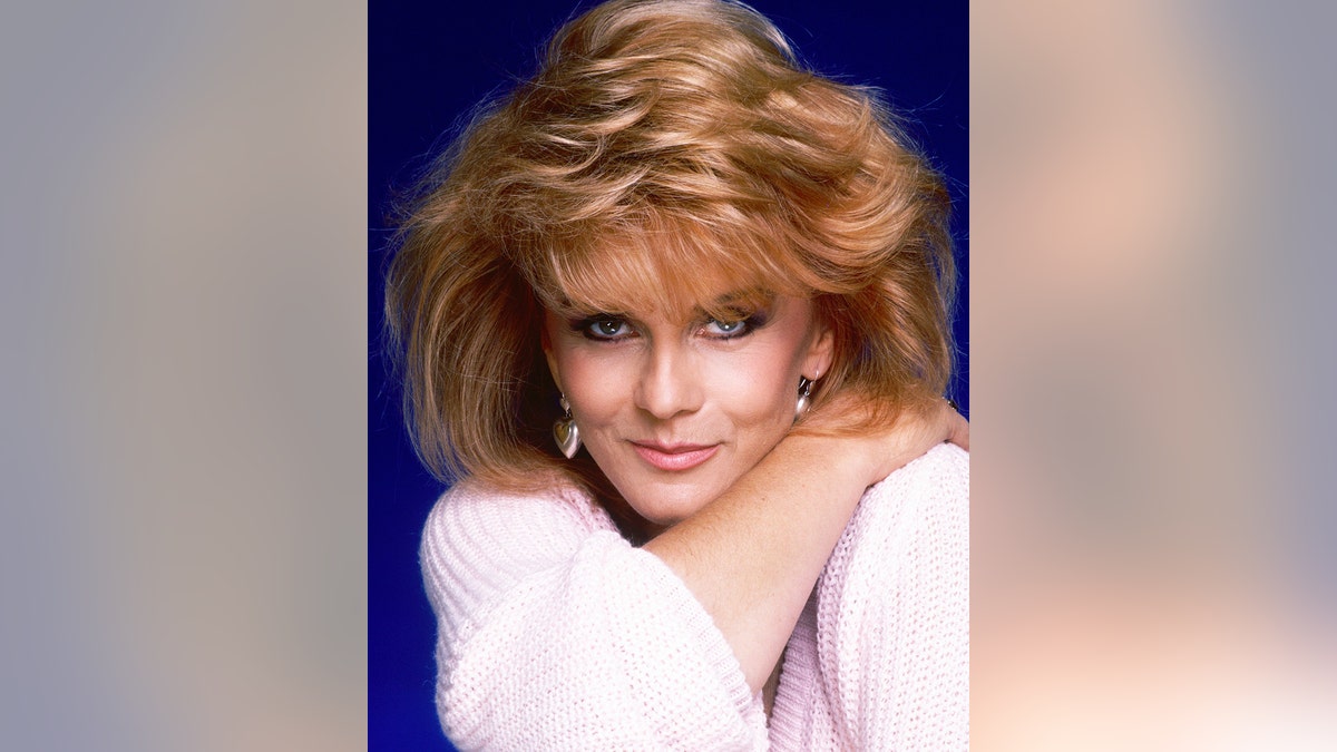 A close-up of Ann-Margret in a glamorous pose wearing a pale pink sweater