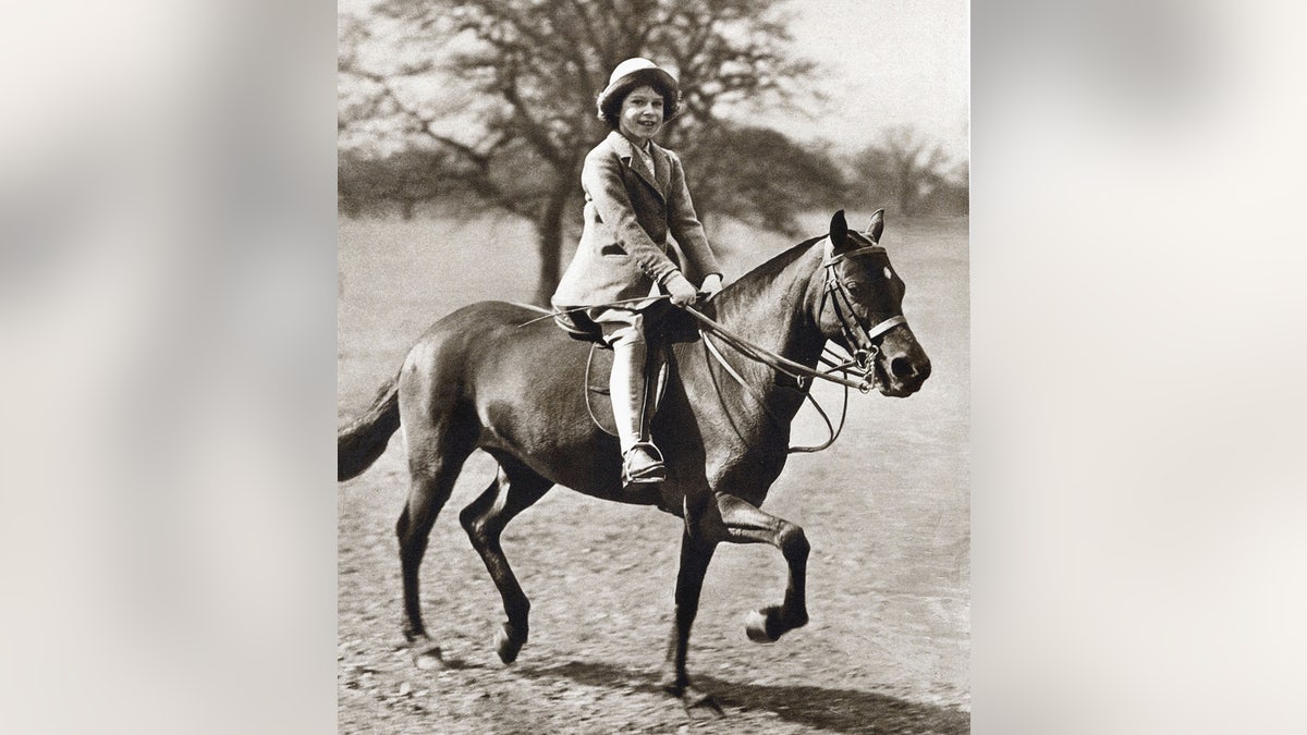 Princess Elizabeth smiling and riding a horse.