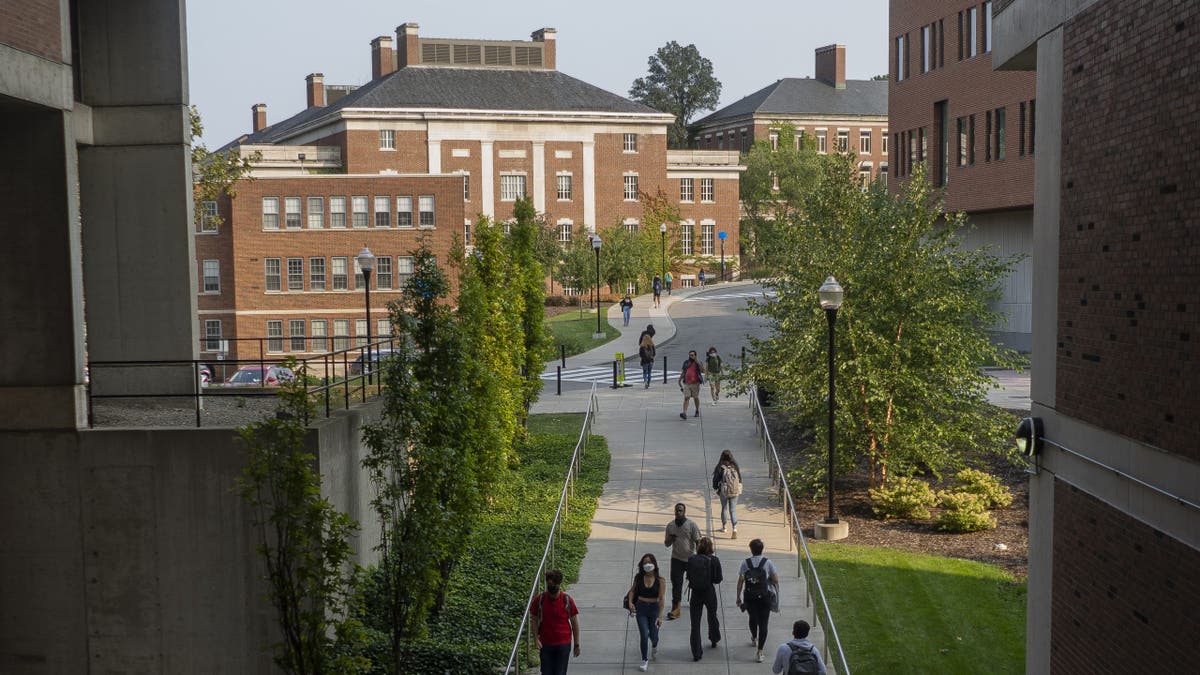 Students walk on the University of Rochester campus near the College of Business Administration