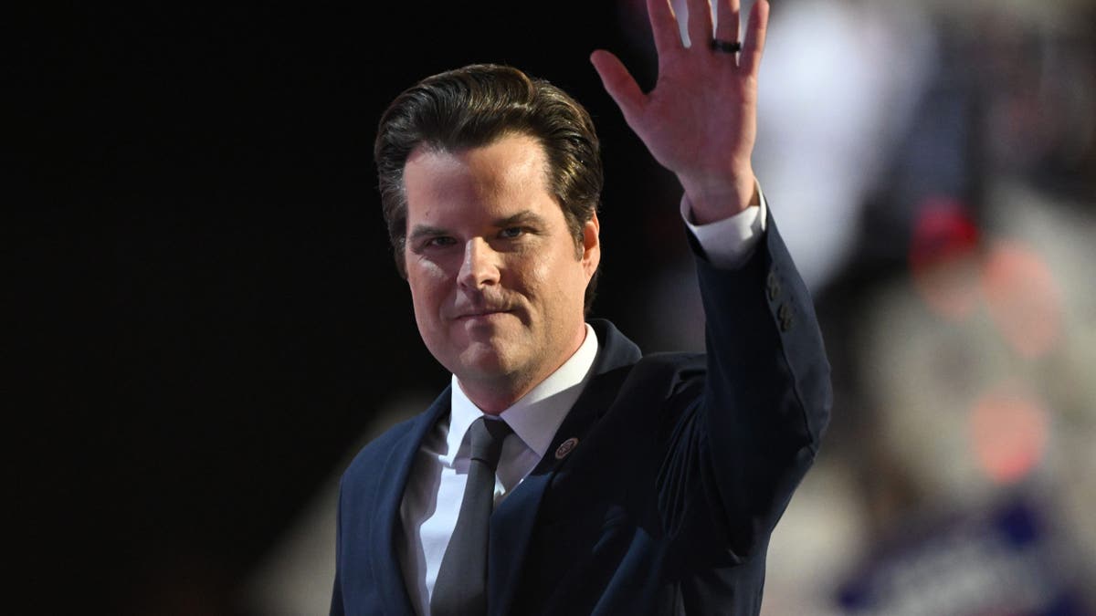 Gaetz raises his hand on the RNC stage