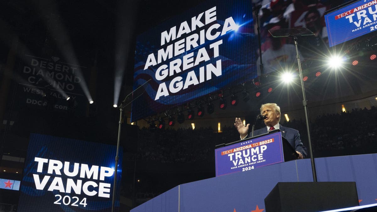 Trump on stage as he speaks from behind a podium at a Glendale rally