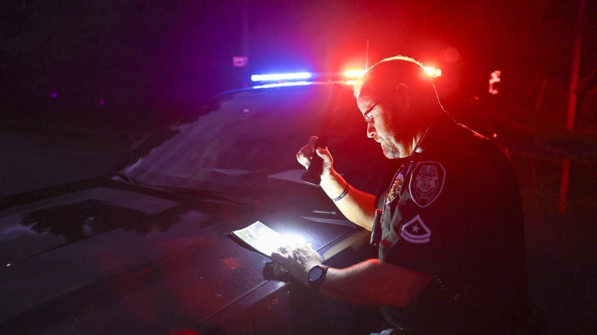 Police officer is seen as Asheville and the western parts of North-Carolina is devastated by the heavy rains and flooding after Hurricane Helene in Asheville, United States on September 30, 2024.