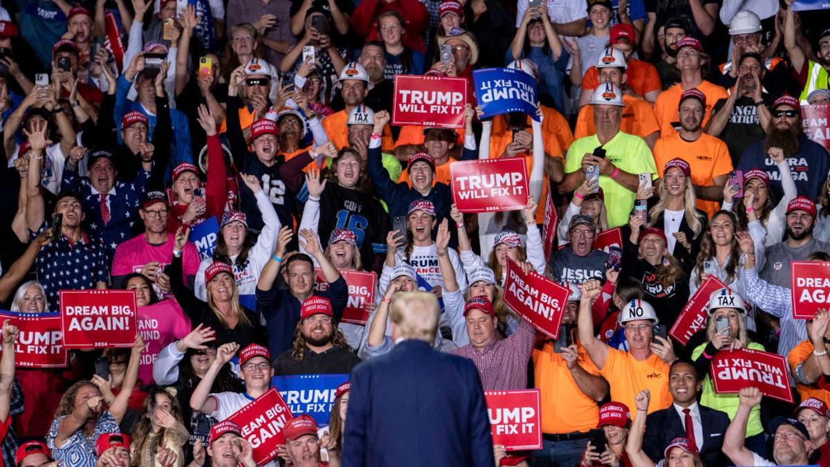 Attendees react to former US President Donald Trump during his closing campaign event at Van Andel Arena in Grand Rapids, Michigan, US, on Tuesday, Nov. 5, 2024.  Photographer: Sarah Rice/Bloomberg via Getty Images