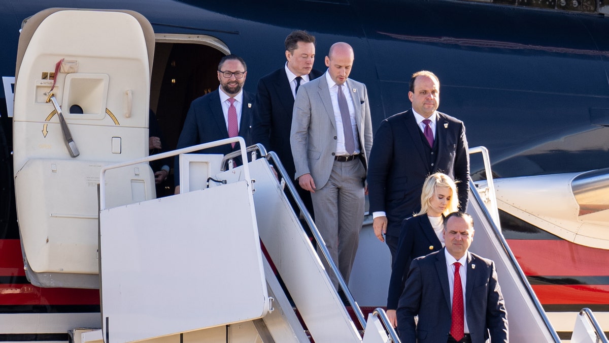 Elon Musk and Trump staffers leaving Trump plane