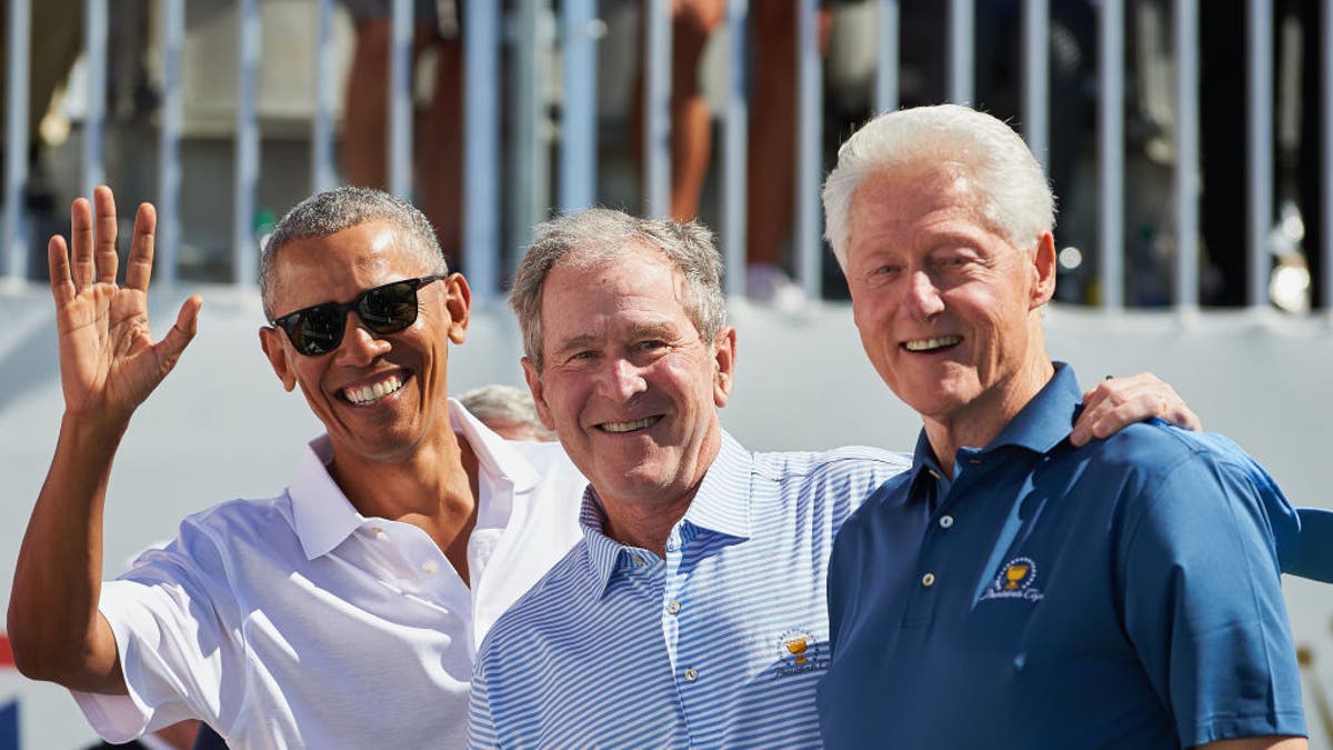 Presidents Obama, George W. Bush and Clinton are shown during the first round of the Presidents Cup at Liberty National Golf Club in Jersey City, N.J., on Sept. 28, 2017.