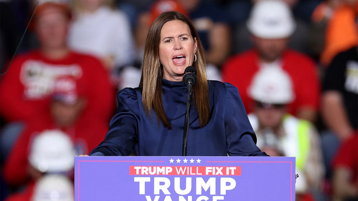 Governor Sarah Sanders at the lectern at the Trump rally