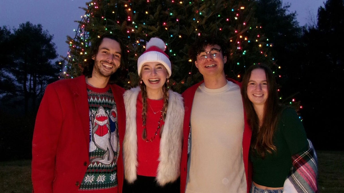 Group at Christmas in front of the tree.