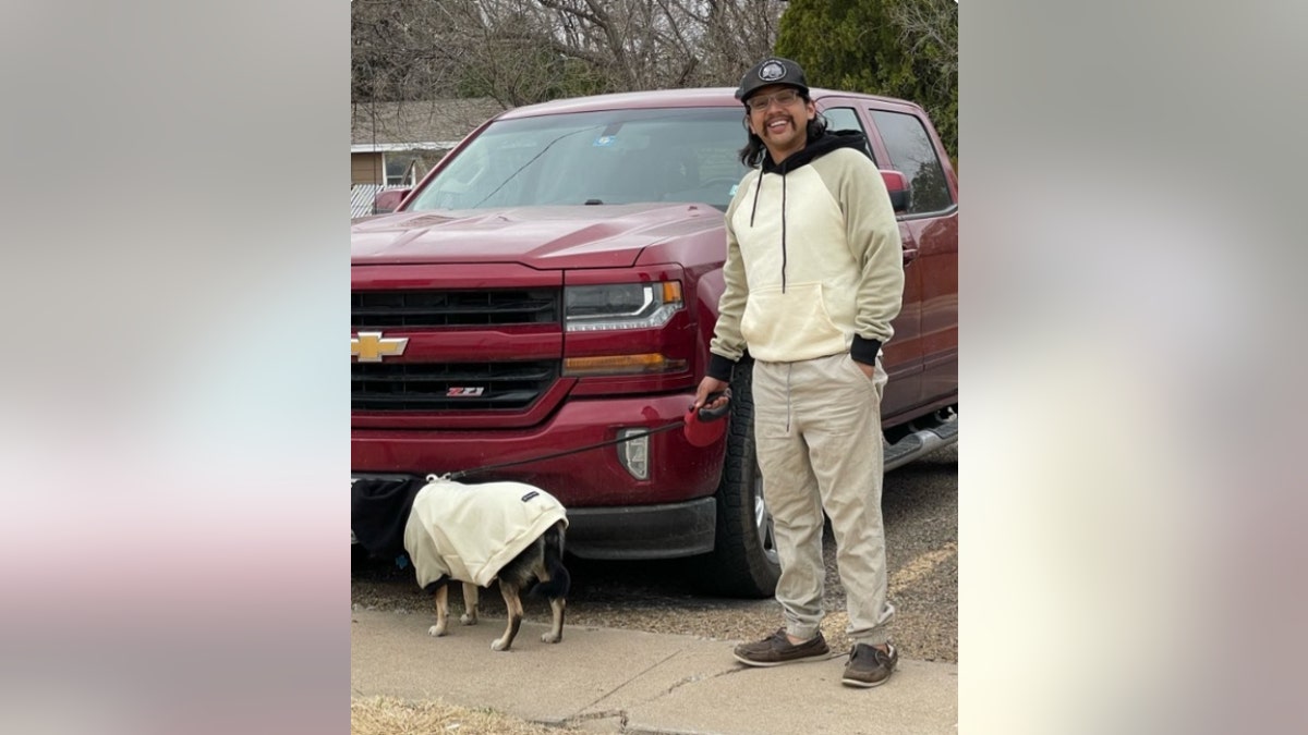 Eluise Torres stands next to a red Chevy truck