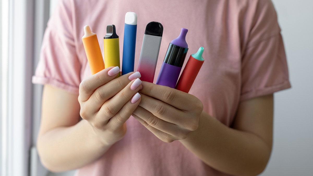 Vape cigarettes in woman hand