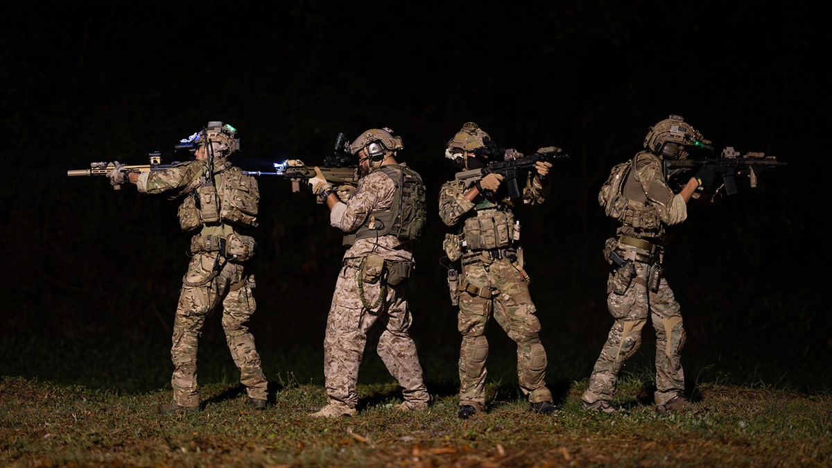 soldiers in camo at night