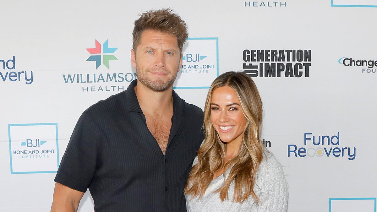 Jana Kramer wears a gray blazer next to her husband, Alan Russell