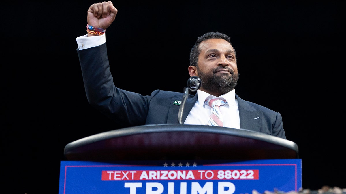 Cash Patel lifted his arm behind Lectern