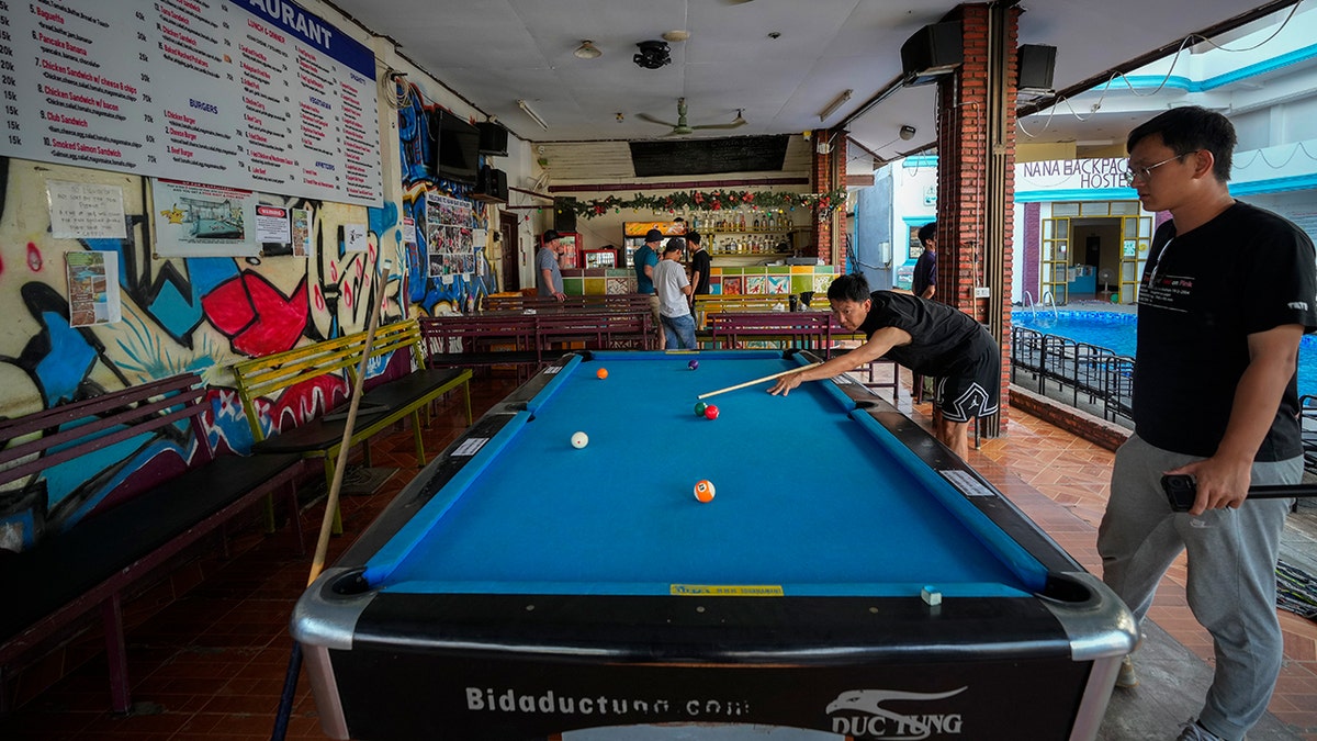 Man play pool in Laos