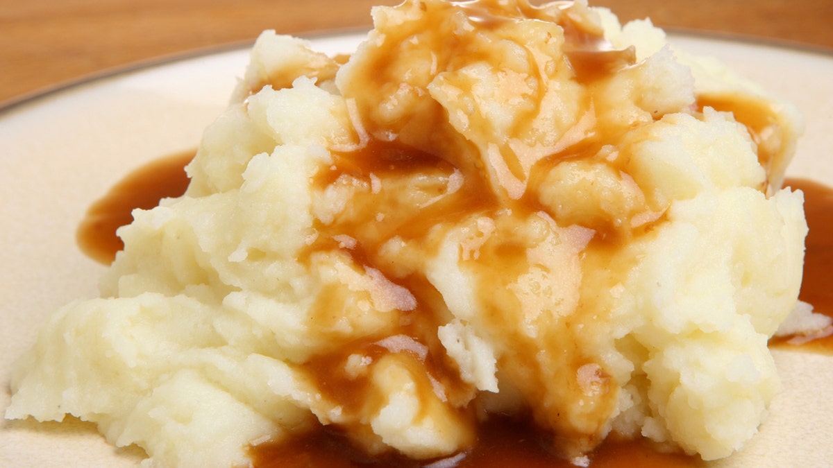 A closeup of mashed potatoes and gravy.