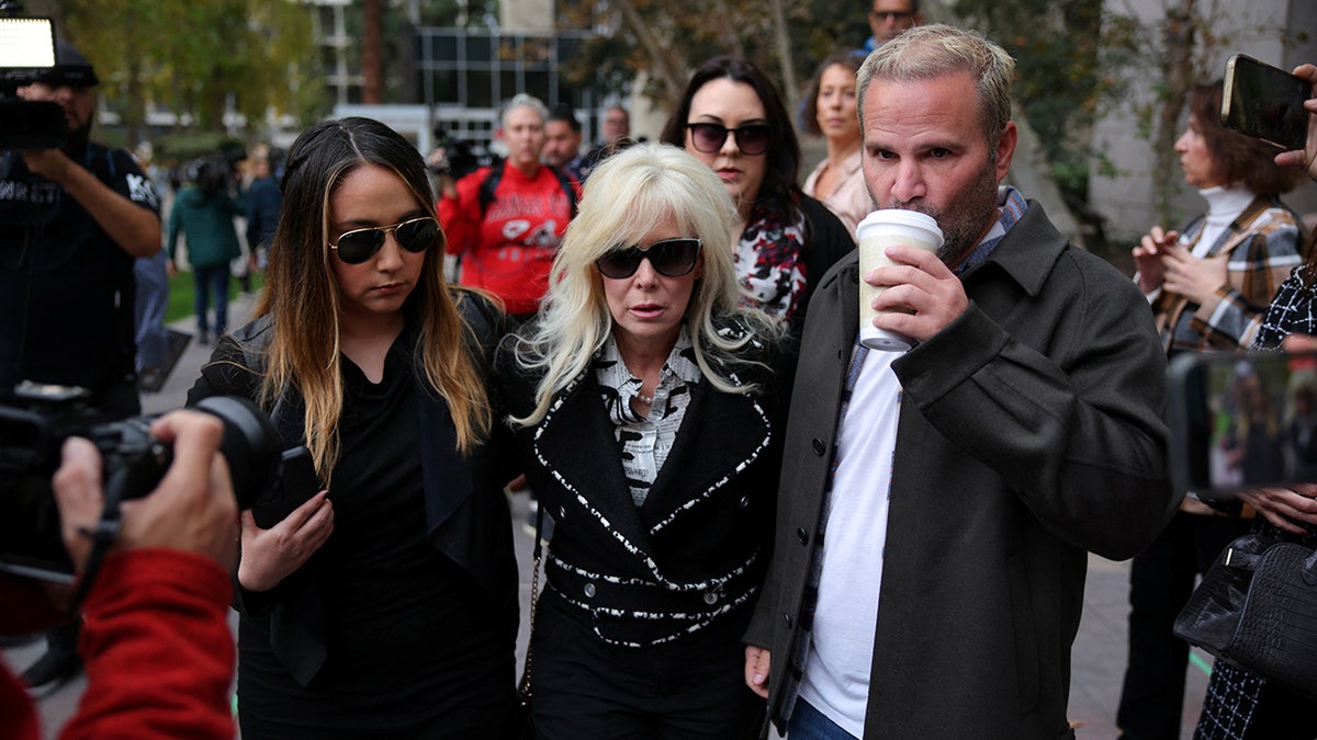 Tammi Menendez, Erik Menendez' wife, and Erik Menendez' stepdaughter locomotion  adjacent   the Van Nuys Courthouse