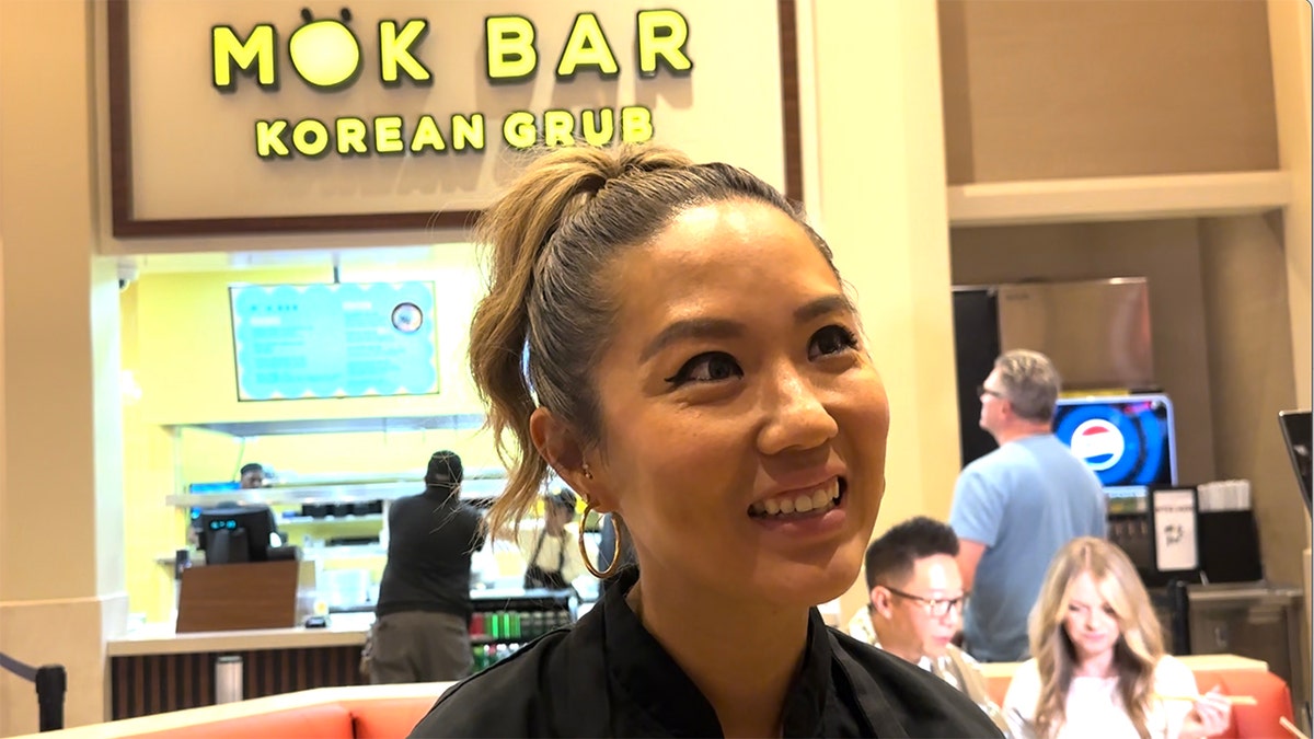 Esther Choi standing in front of her new restaurant.