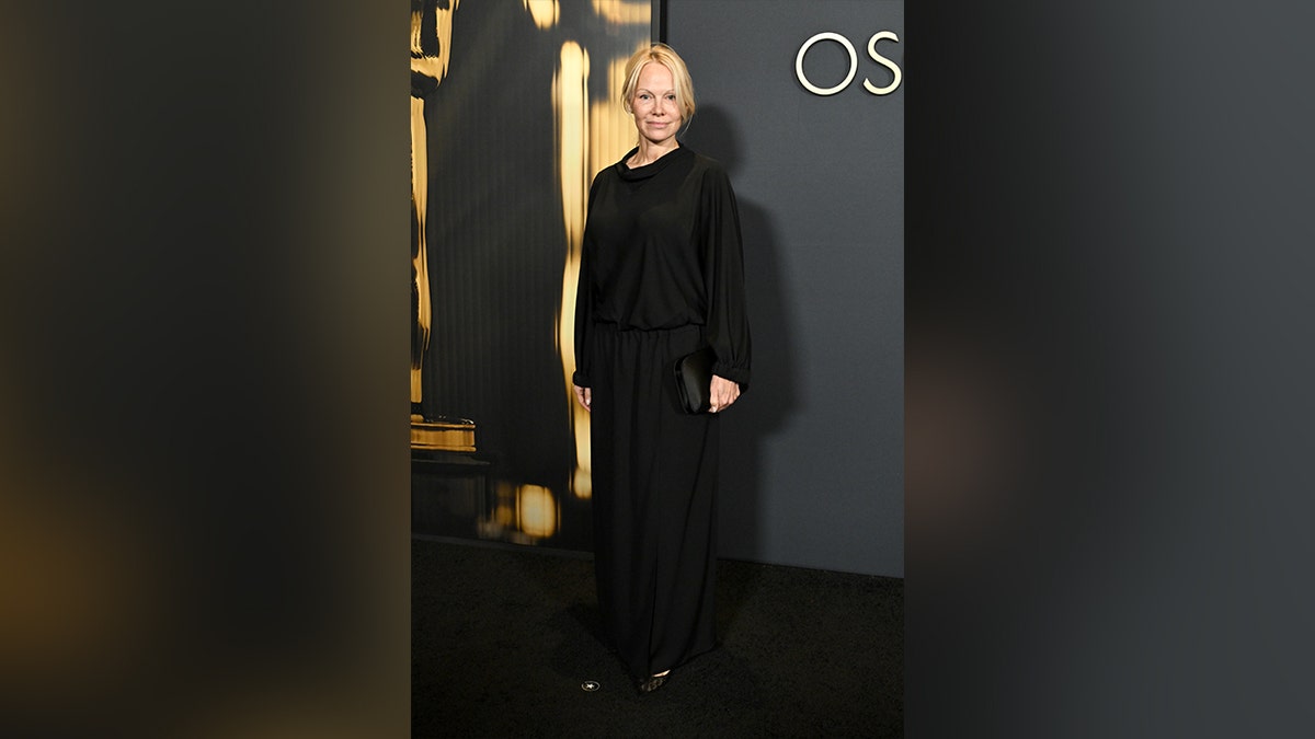 Pamela Anderson wore a long sleeve black Giorgio Armani dress to the Governors Awards.