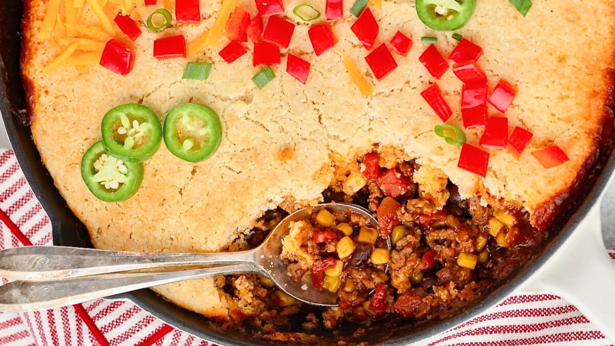 The Cowboy Cornbread Casserole is served in a cast iron skillet.