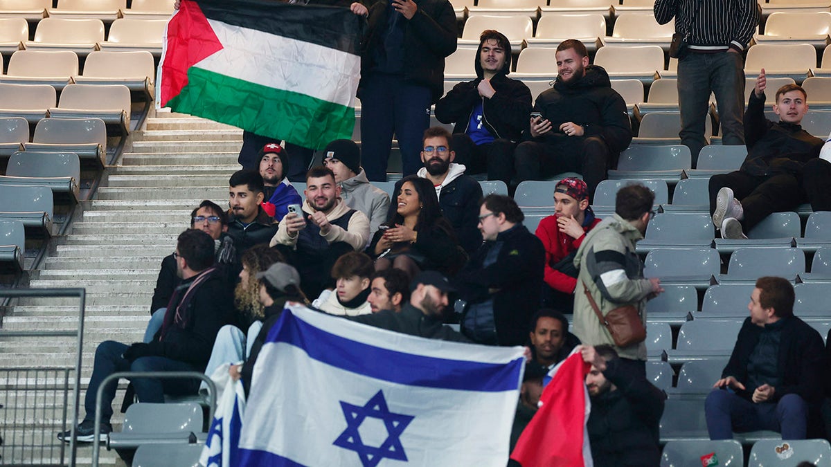 Fans hold Israel and Palestine flag