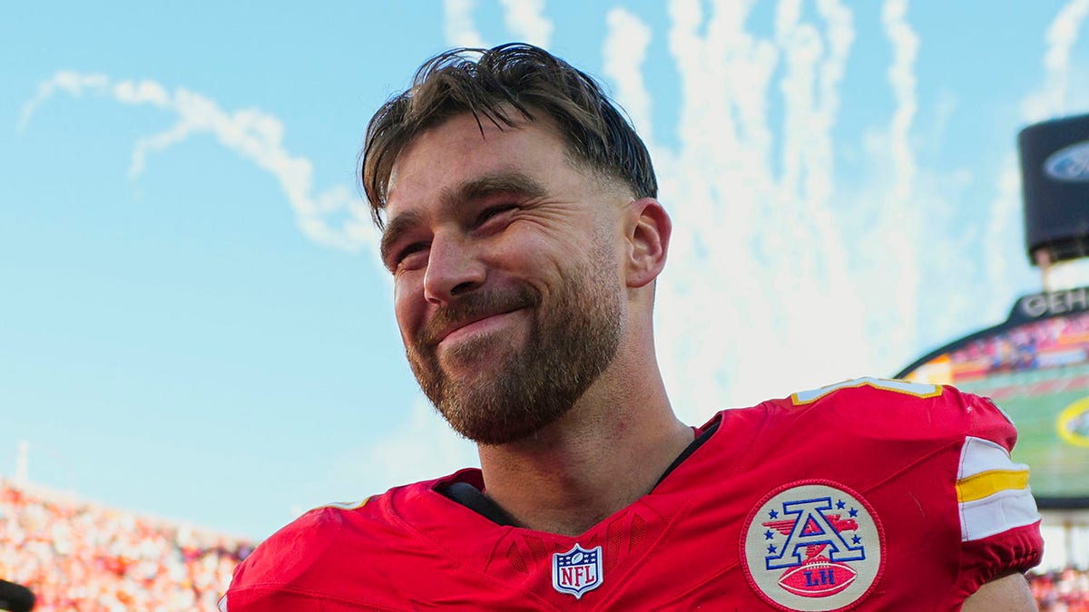 Travis Kelce smiles on field