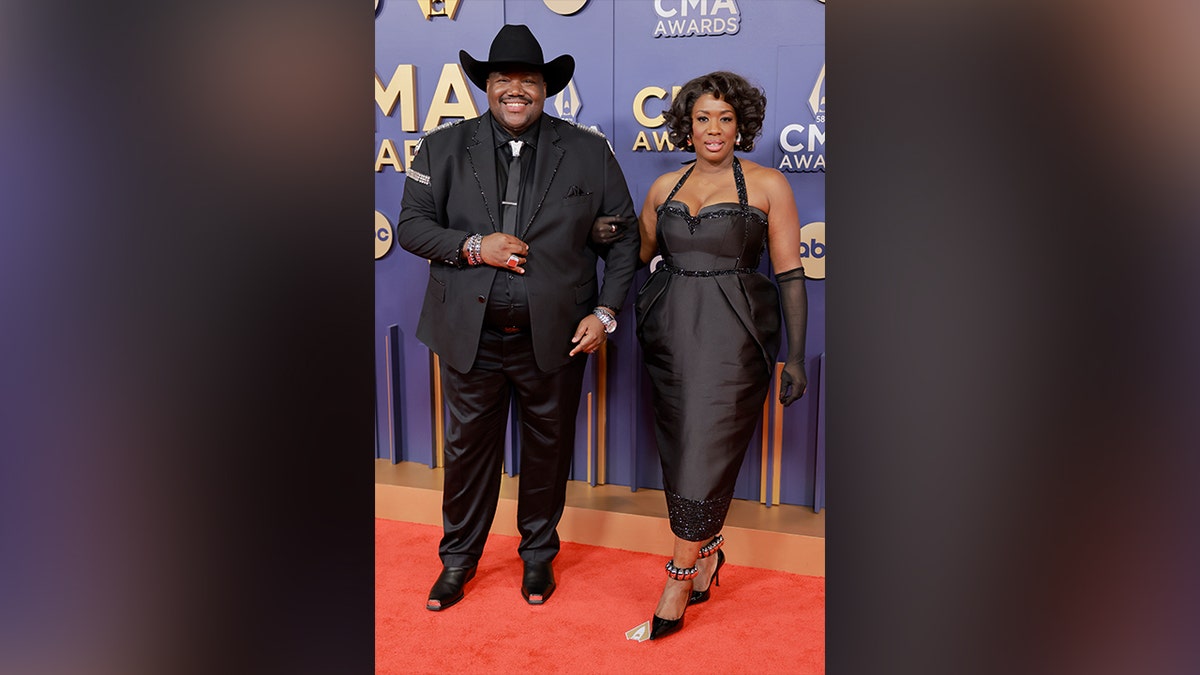 Members of the band War and Treaty, waled the red carpet at the 2024 CMA Awards red carpet in black outfits.