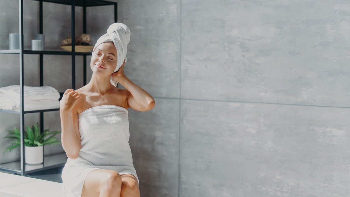 Woman wrapped in a towel after a shower