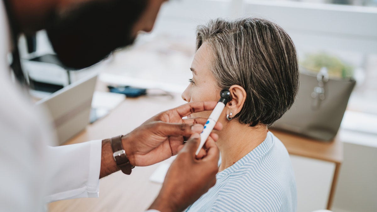 Woman ear exam