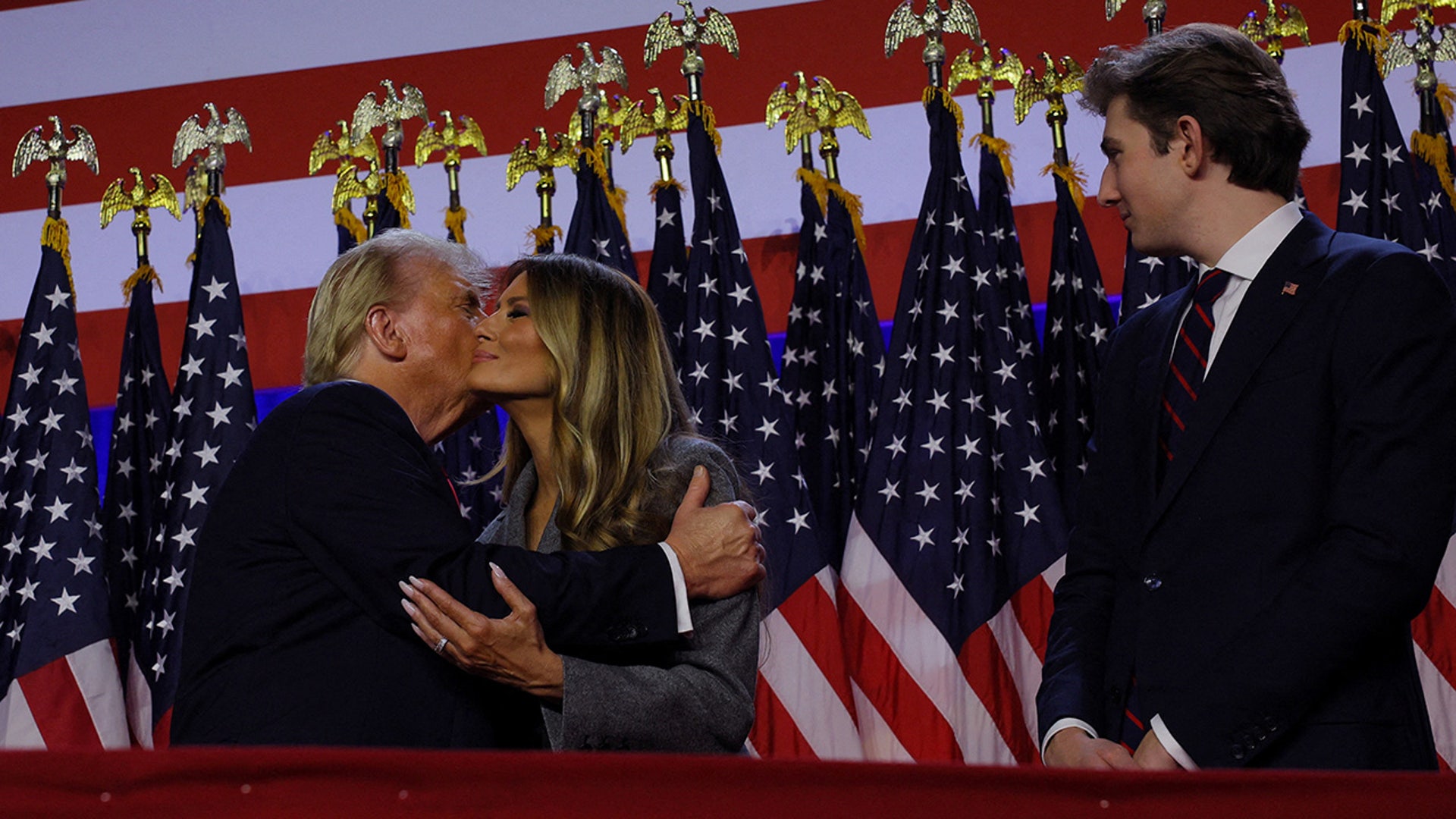 Republican presidential nominee and former U.S. President Donald Trump hugs his wife Melania, as they stand next to and Barron Trump, at Donald Trump's rally at the Palm Beach County Convention Center