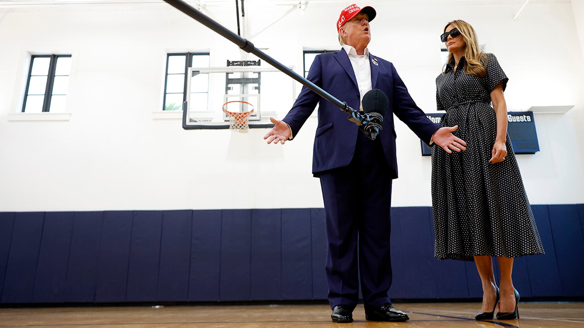 Republican presidential nominee former President Donald Trump and his wife Melania Trump talk to reporters after casting their votes at the polling place in the Morton and Barbara Mandel Recreation Center