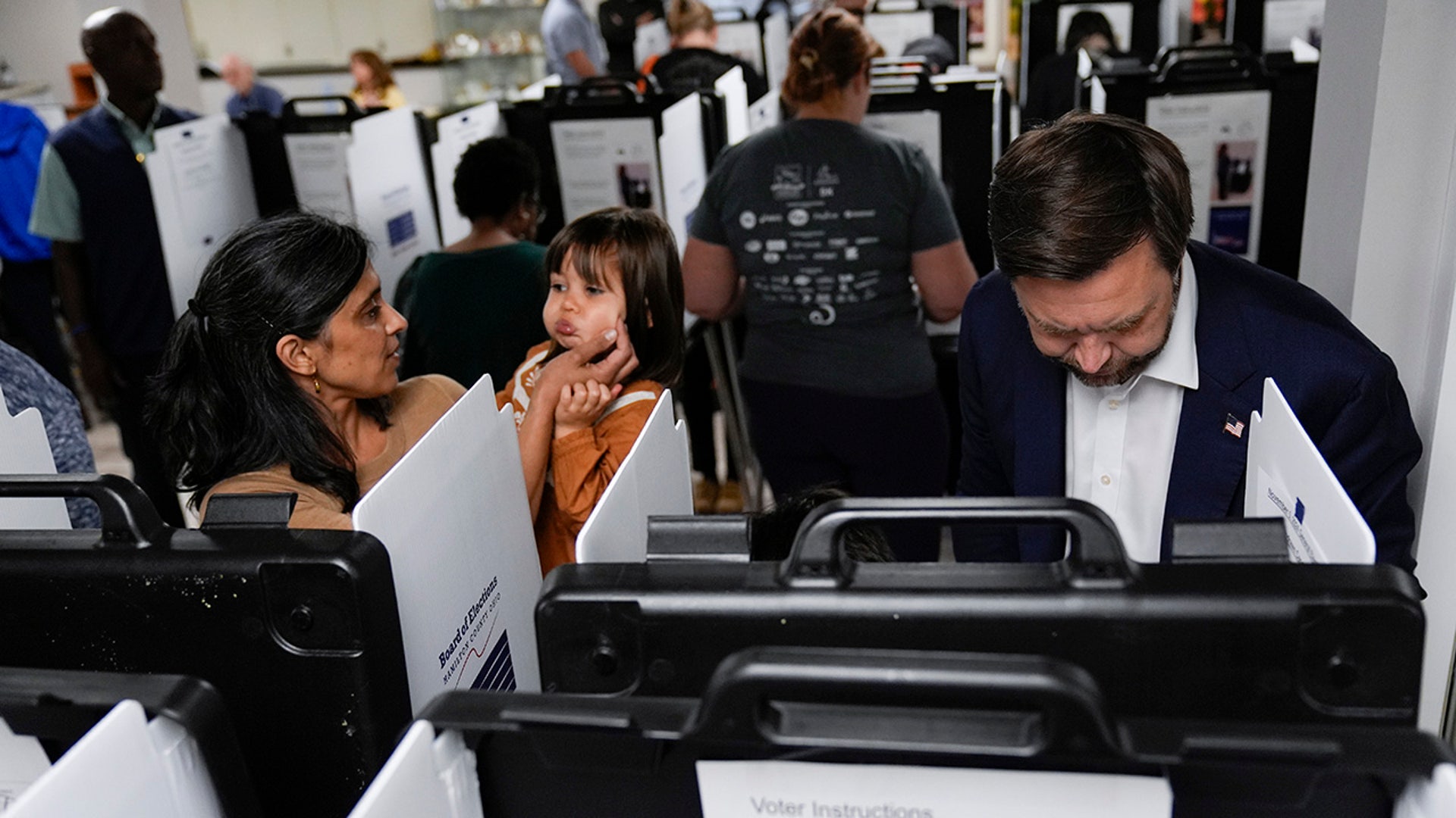 Republican vice presidential nominee Sen. JD Vance, R-Ohio, his wife Usha Vance and daughter, votes at the St Anthony of Padua Maronite Catholic Church