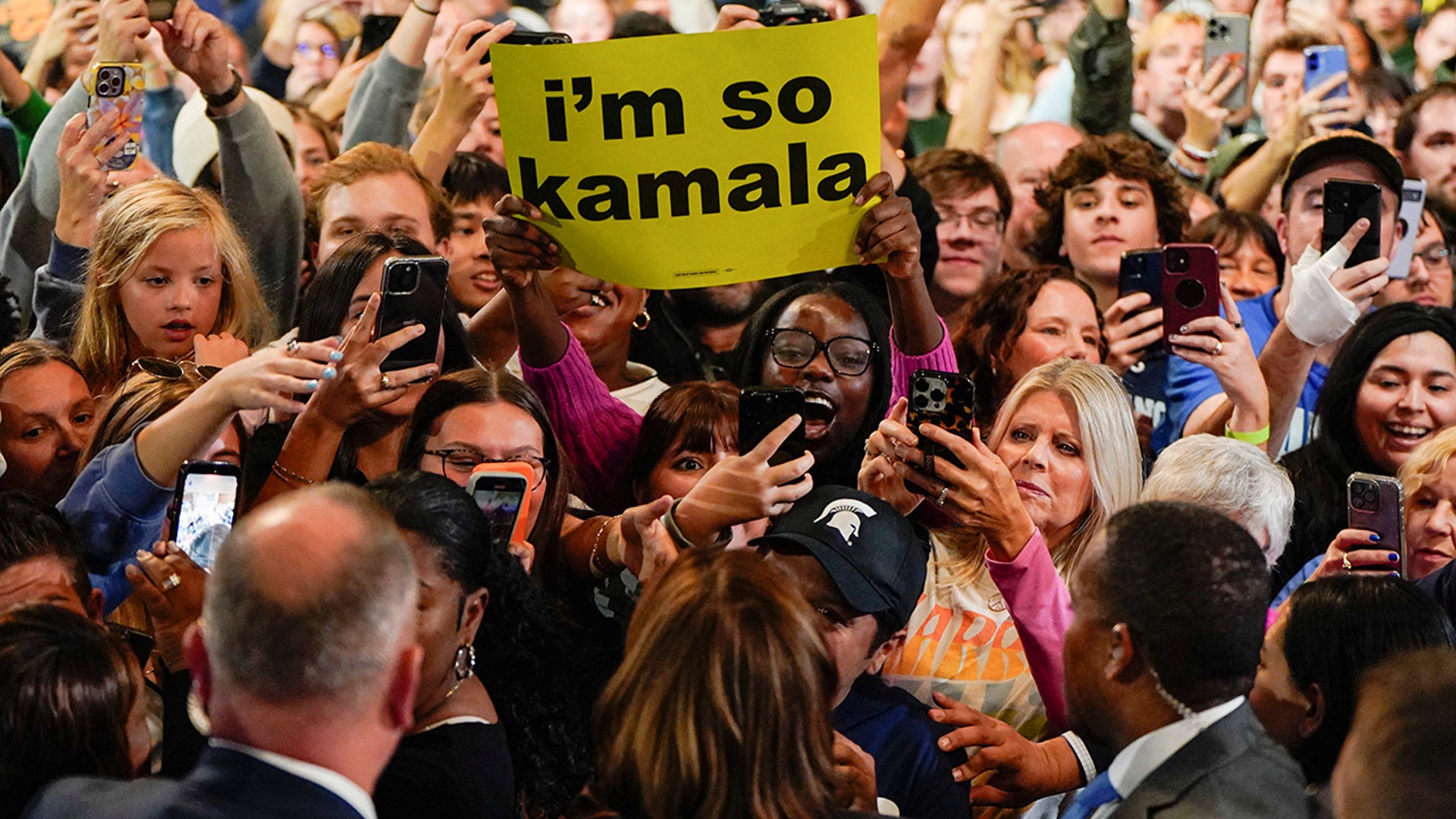 Supporters gather around Democratic presidential nominee Vice President Kamala Harris during her rally at Michigan State University