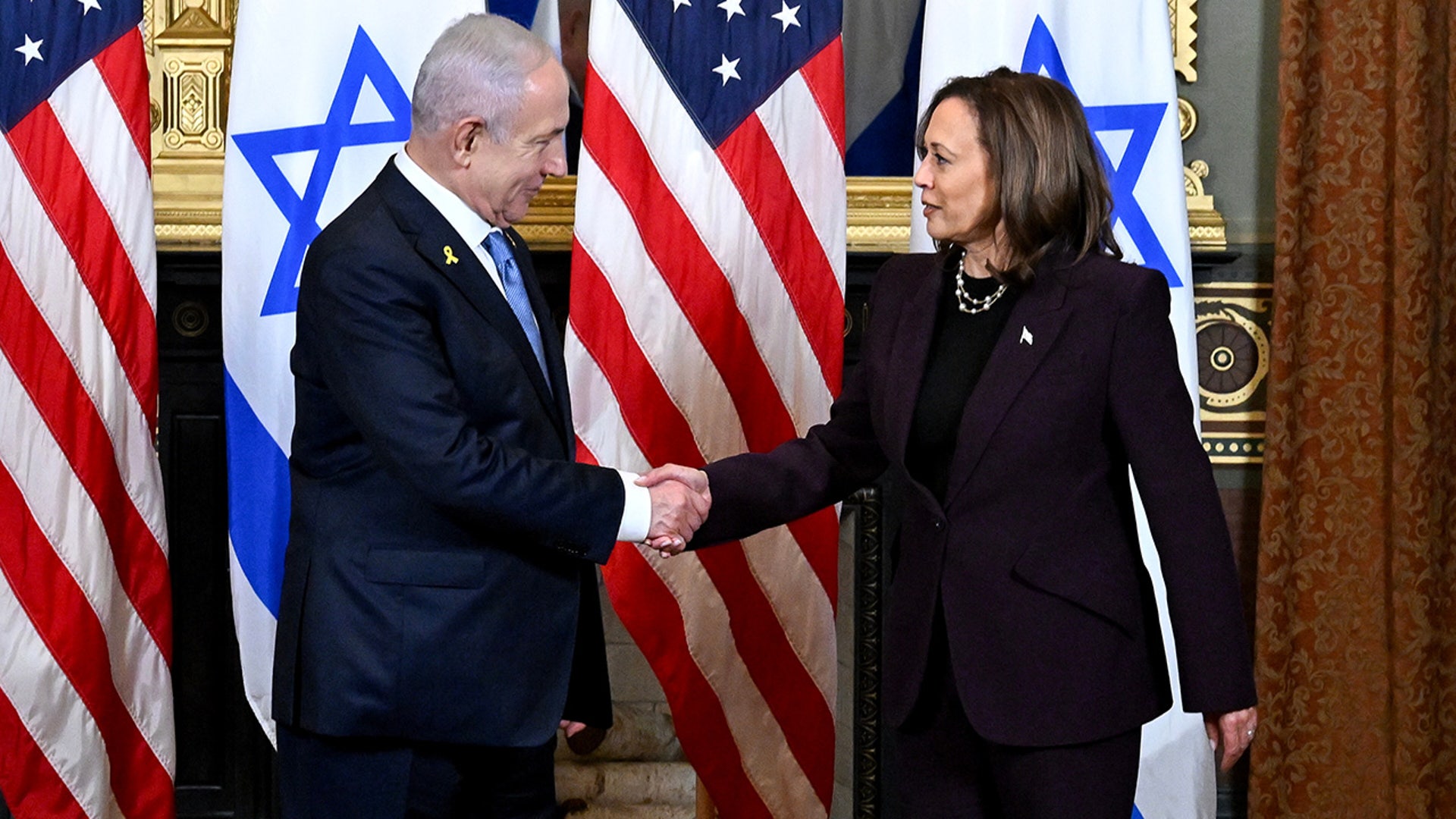 Benjamin Netanyahu, Israel's prime minister and Vice President Kamala Harris shake hands during a meeting in the Vice President's Ceremonial Office