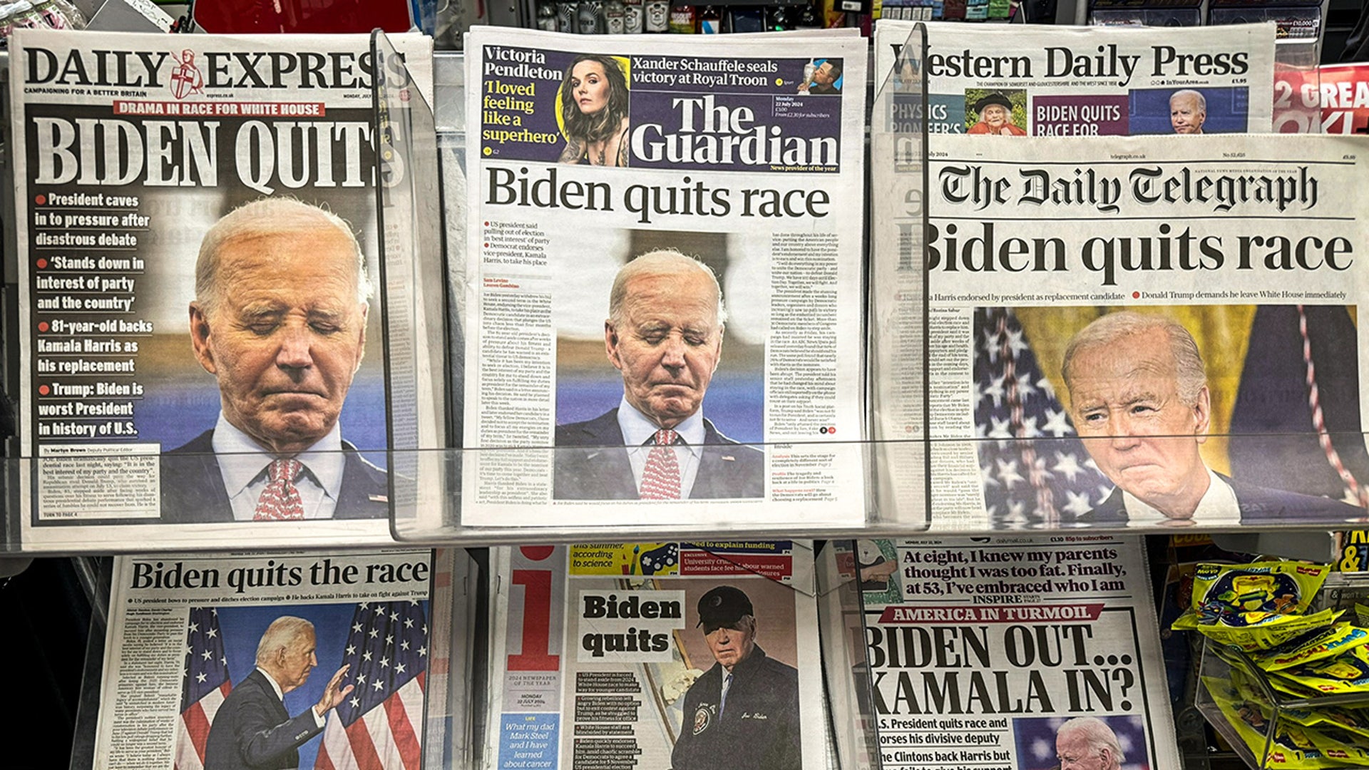 Various UK national newspapers on a newsstand in a newsagent shop report on the news of President Joe Biden's announcement that he is dropping out of the US presidential race