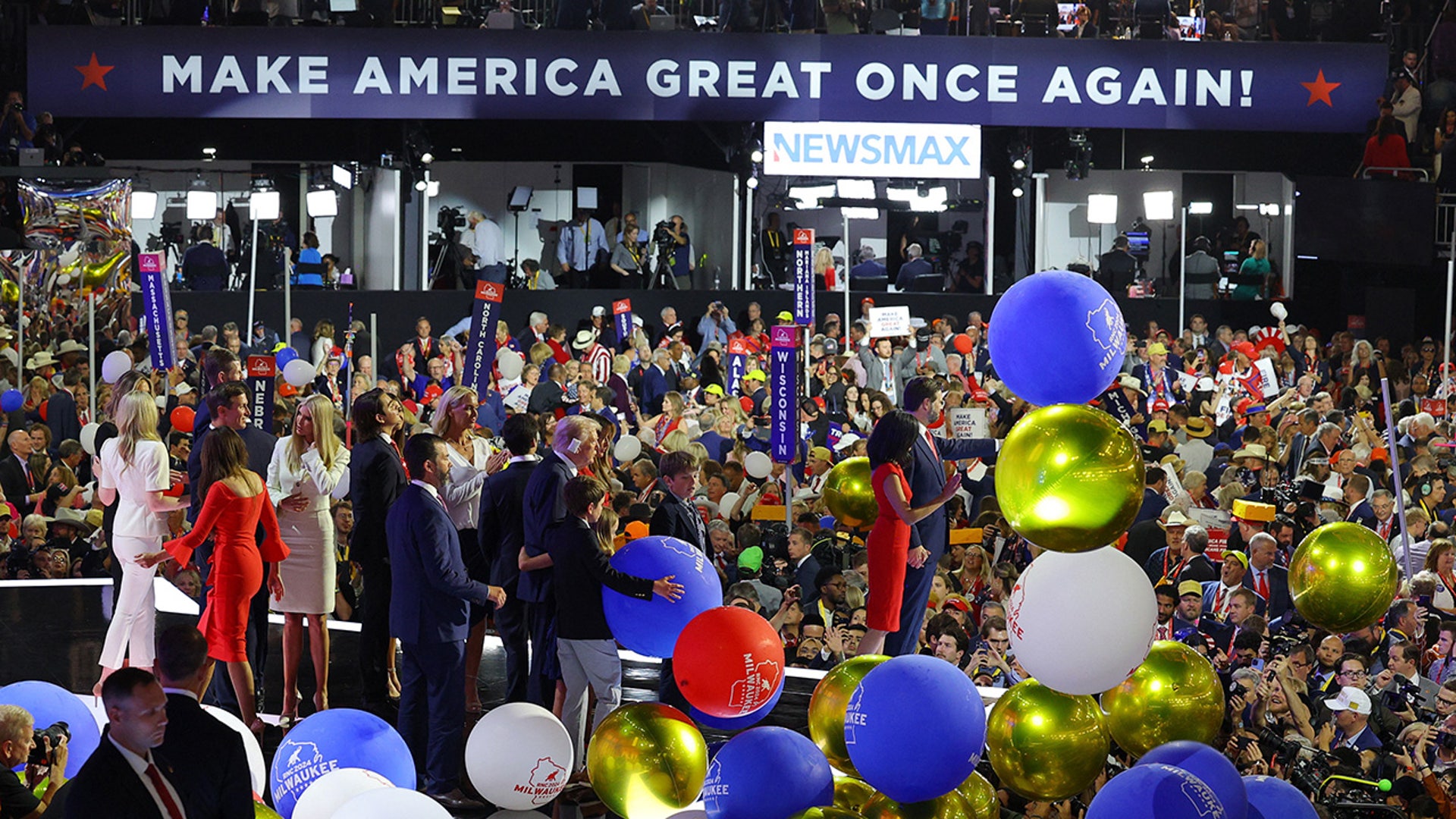 Vice Presidential Nominee Senator J.D. Vance and Usha Chilukuri Vance wave as Republican presidential nominee and former President Donald Trump and his family face the crowd following his speech on Day 4 of the Republican National Convention