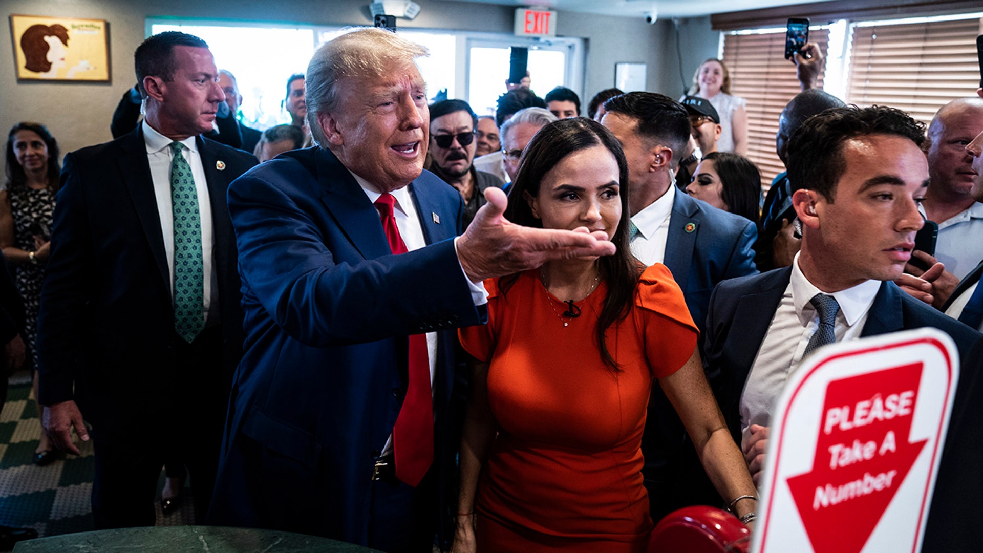 Former President Donald Trump greets supporters and patrons at Versailles Cuban Restaurant