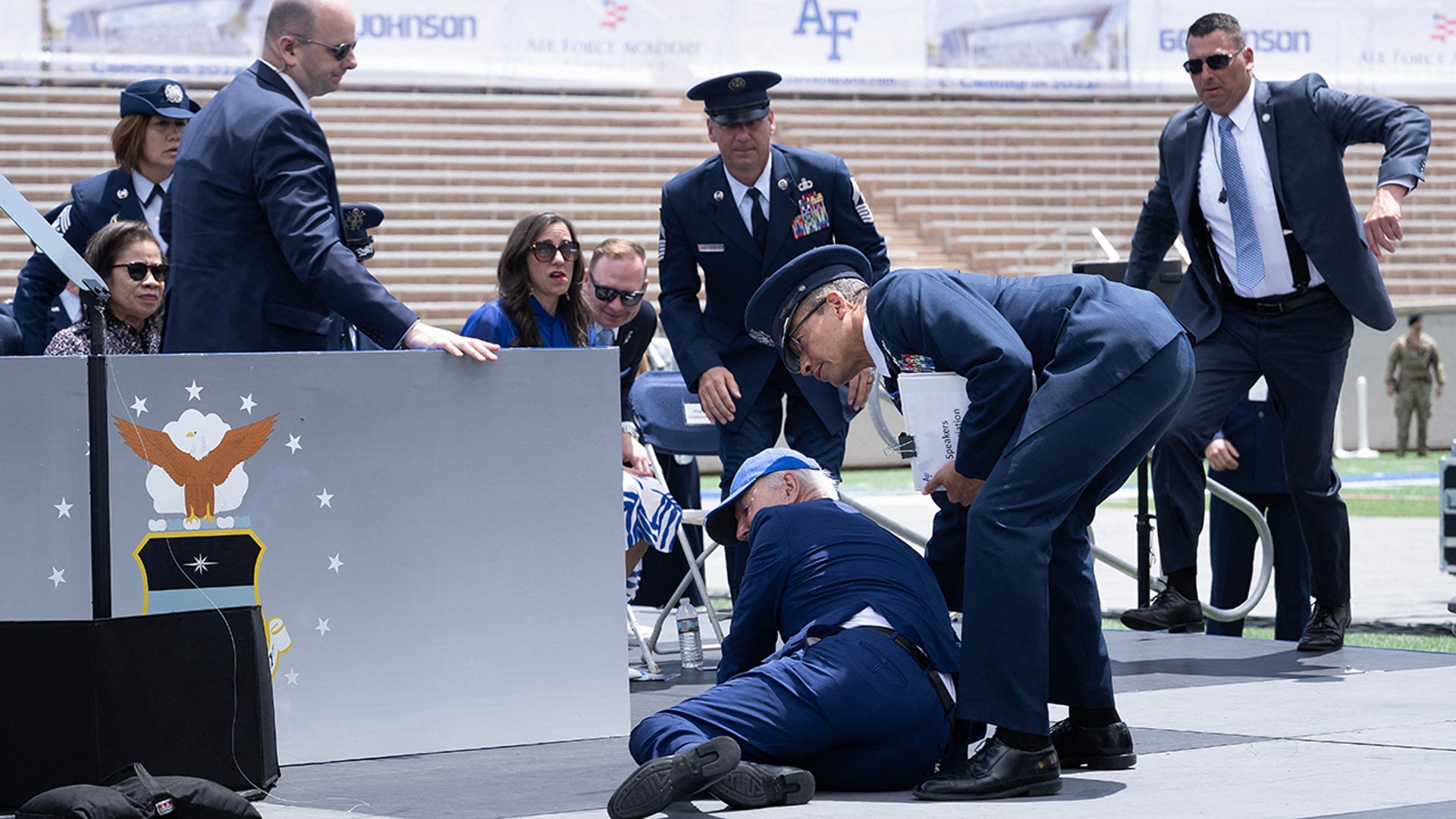 President Joe Biden is helped up after falling during the graduation ceremony at the United States Air Force Academy