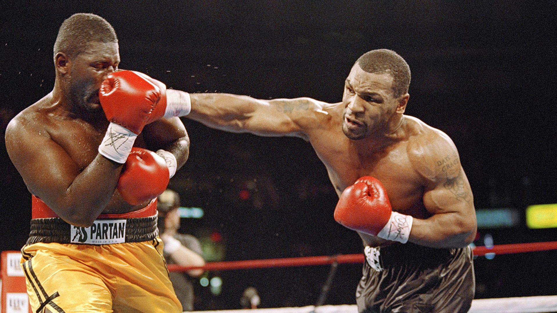 Mike Tyson lands punch