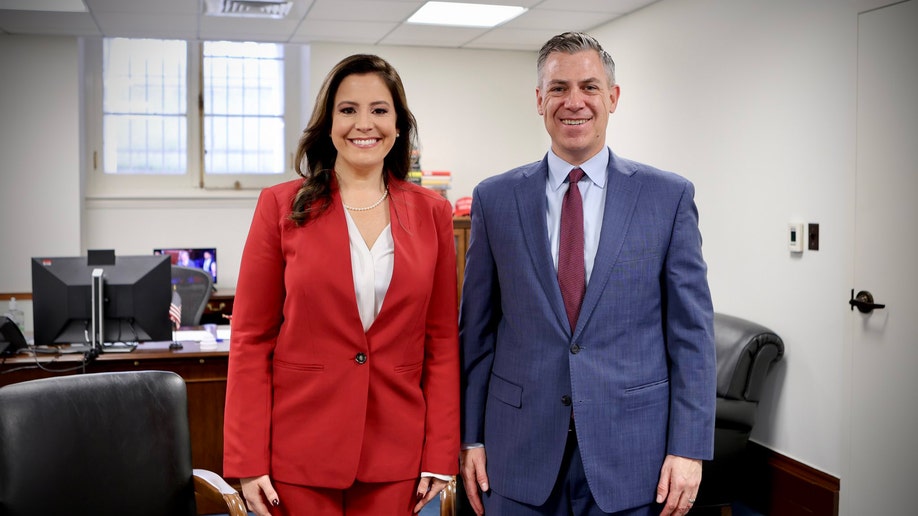 Stefanik and Banks smile side by side