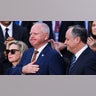 Tim Walz is comforted by second gentleman Doug Emhoff